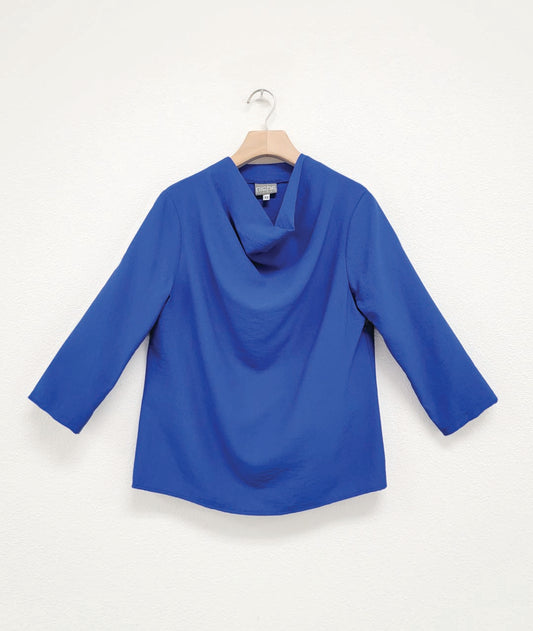 cobalt color pullover top with 3/4 sleeves and a high cowl neckline