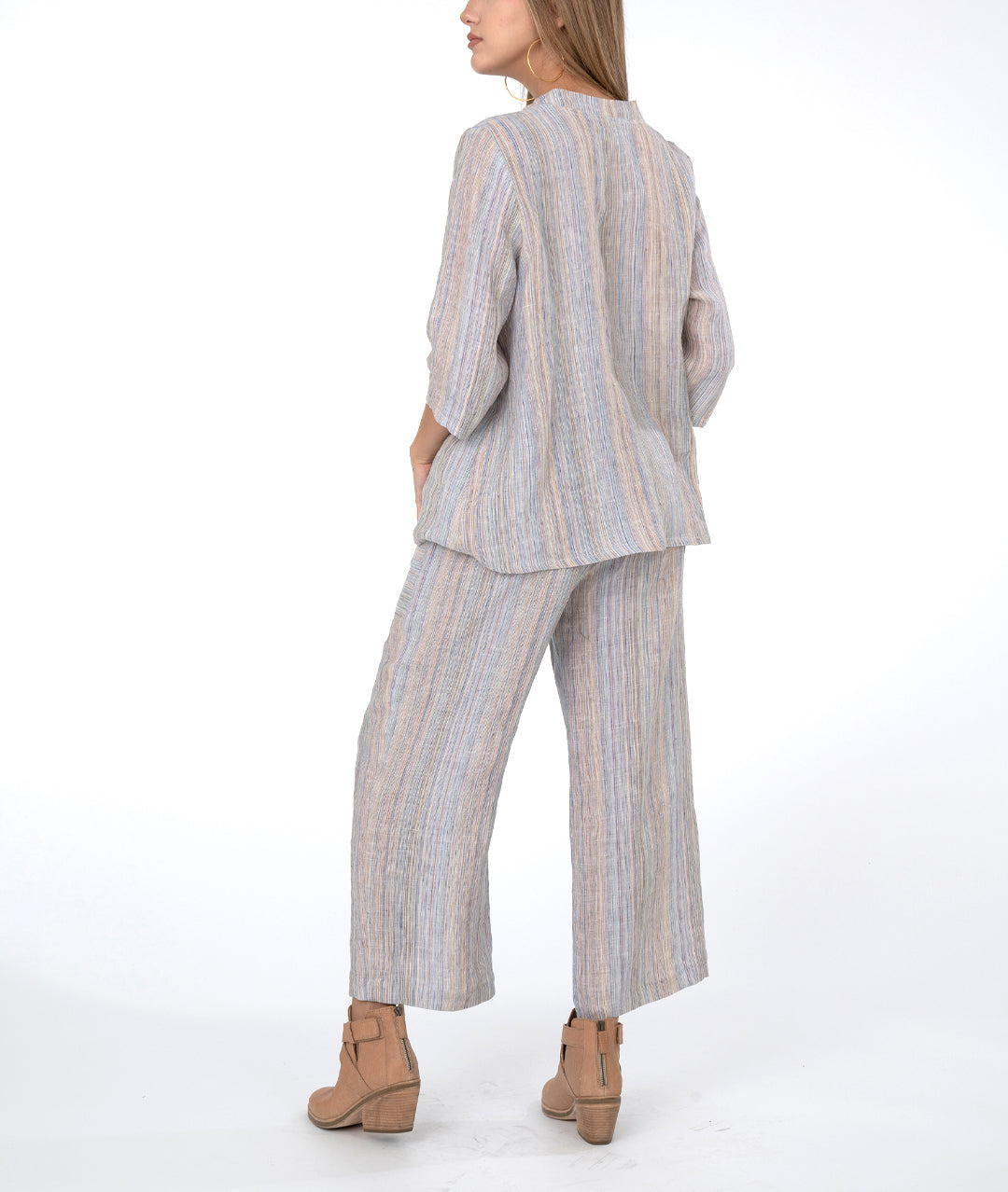 model in multi color striped wide leg pant with a matching botton down top