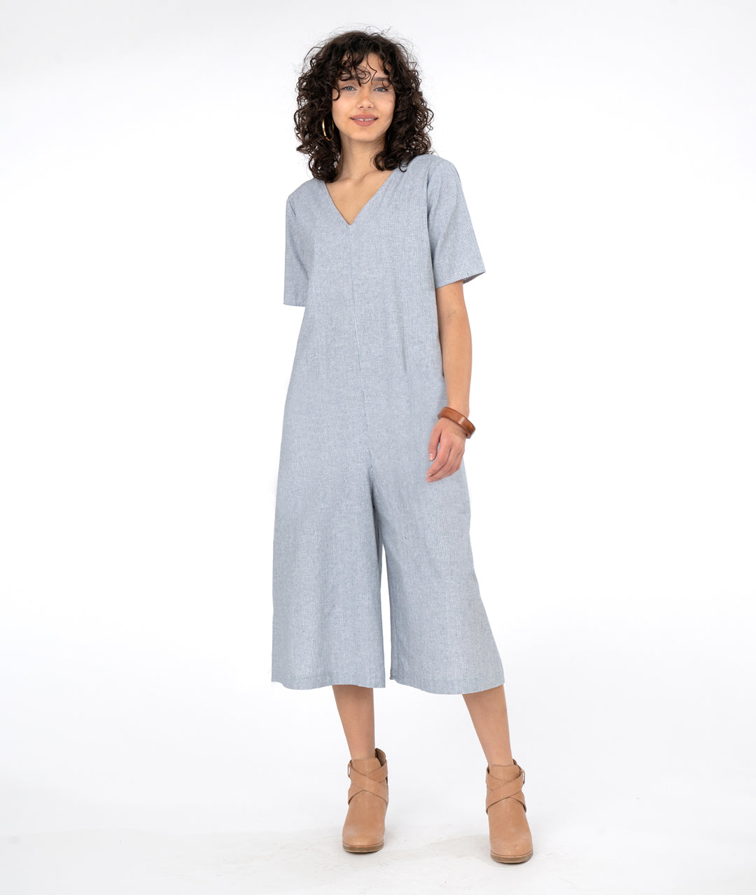 model in a wide, cropped leg jumpsuit with a loose fitting body, short sleeves and a vneck