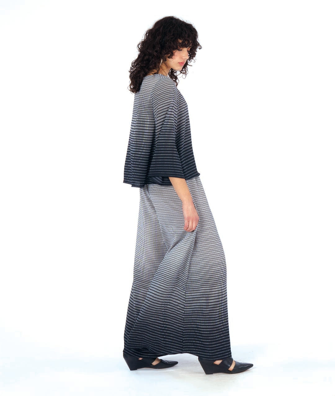 model in a wide leg pant with a matching boxy top, both in a black and white gradiant print