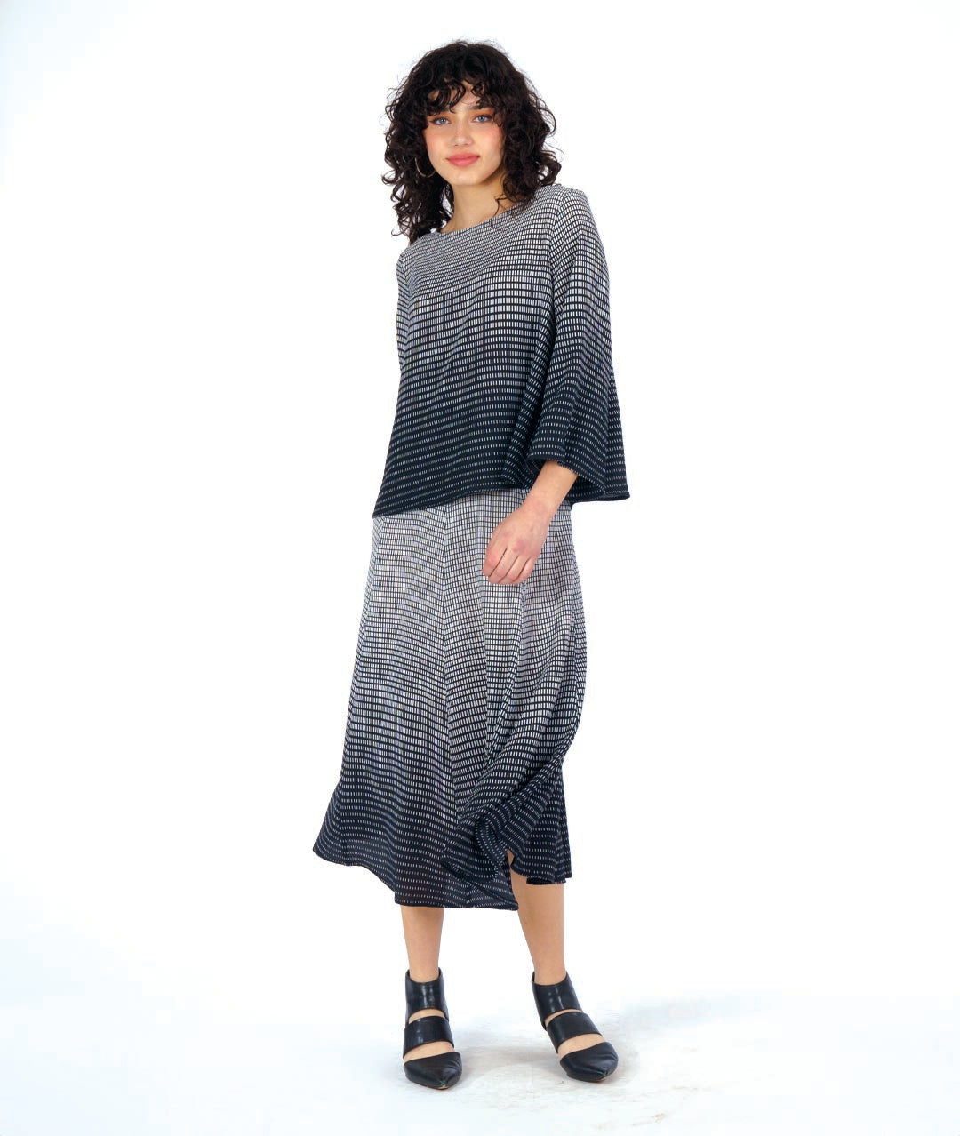 model in a FLOWY SKIRT with a matching boxy top, both in a black and white gradiant print