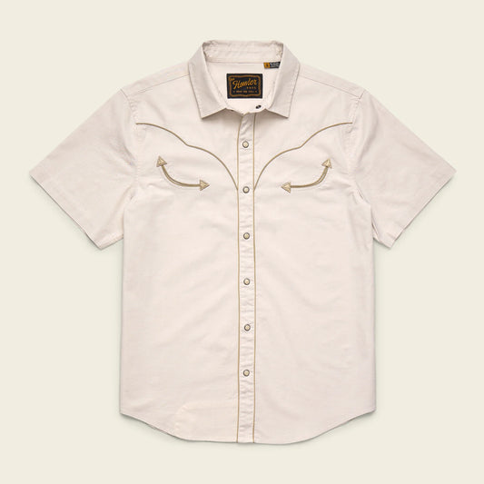 Light-colored short-sleeve shirt with embroidered details on a beige background