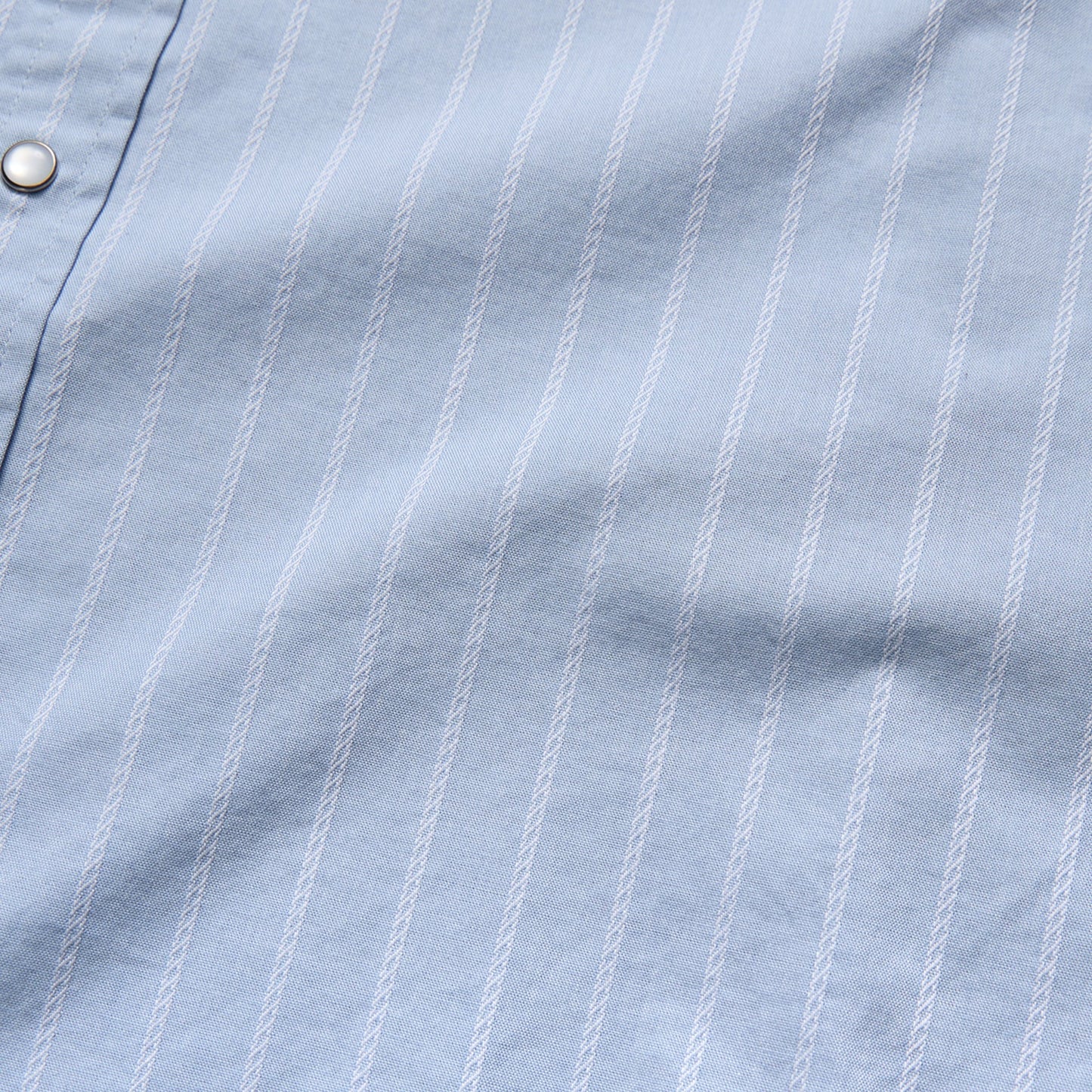 close up stripe pattern on blue shirt