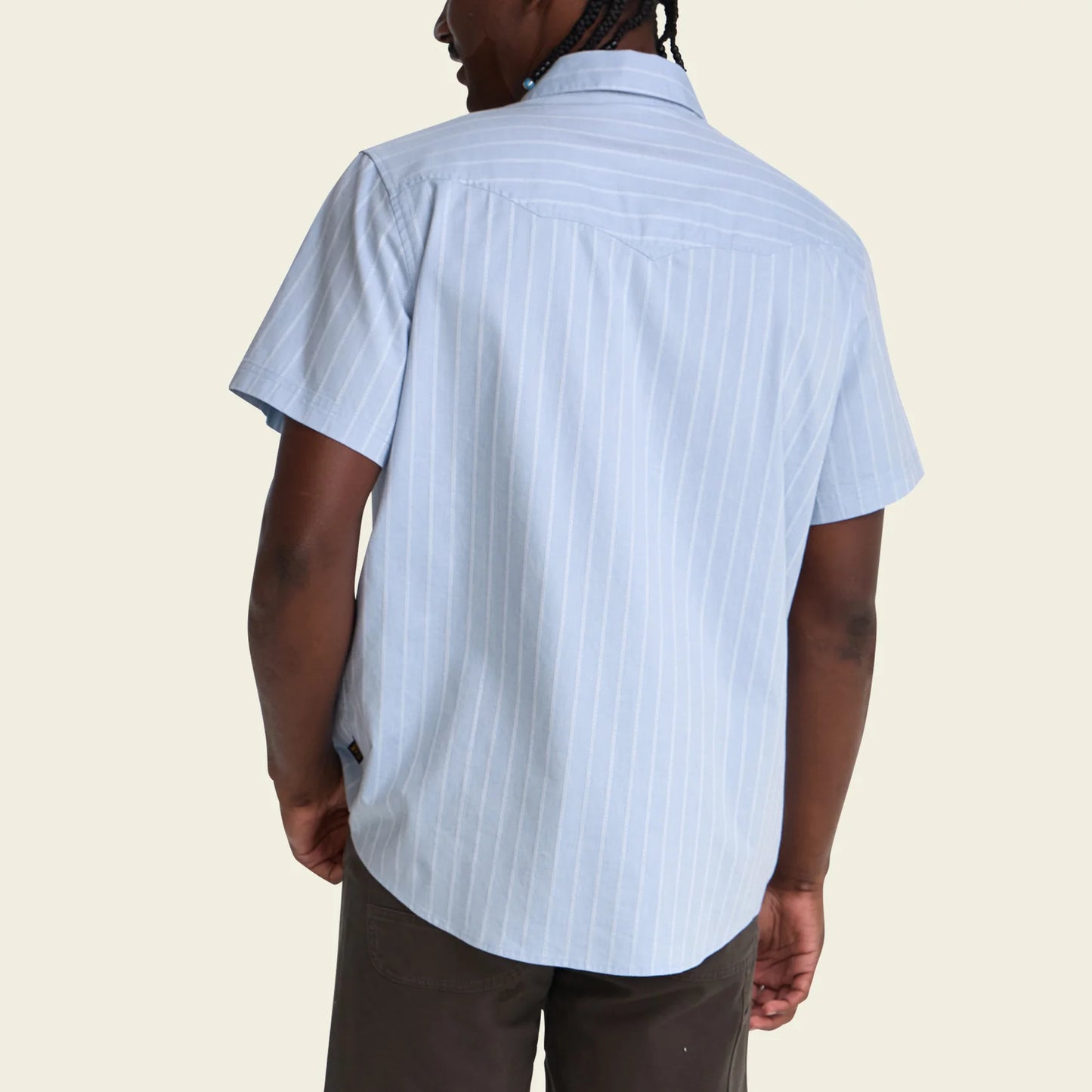 model showing back of blue short sleeve shirt with stripe pattern on white background