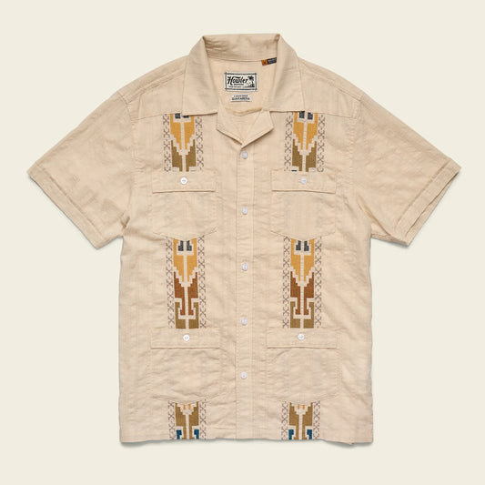 Beige short-sleeve shirt with geometric patterns on a beige background