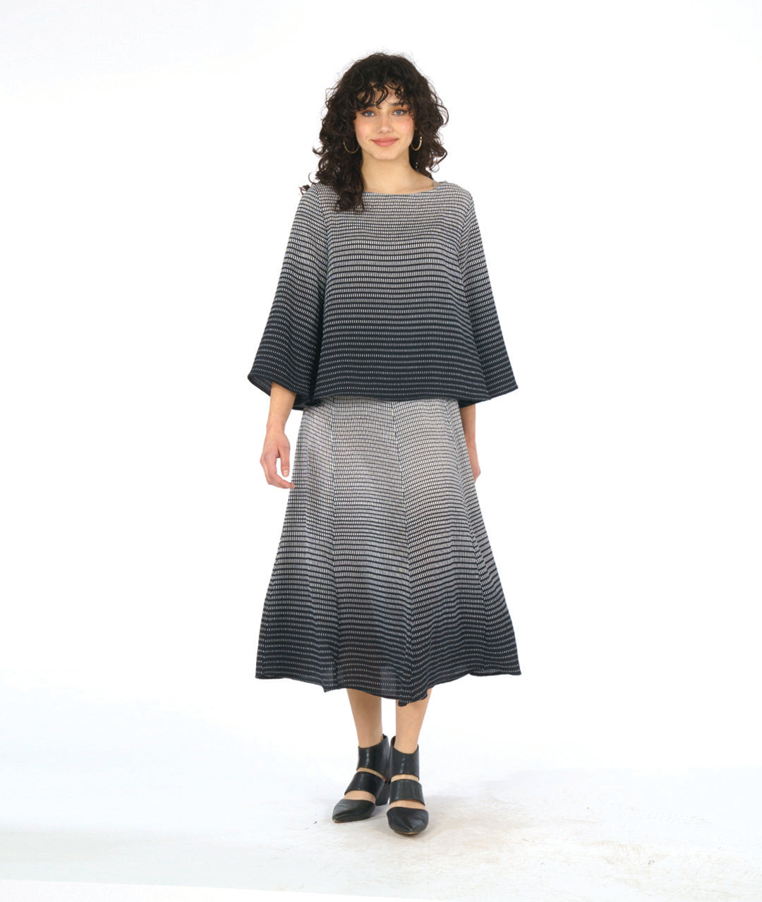 model in a black and white ombre grid print paneled skirt with a matching boxy top