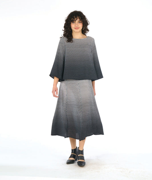 model in a black and white ombre grid print paneled skirt with a matching boxy top