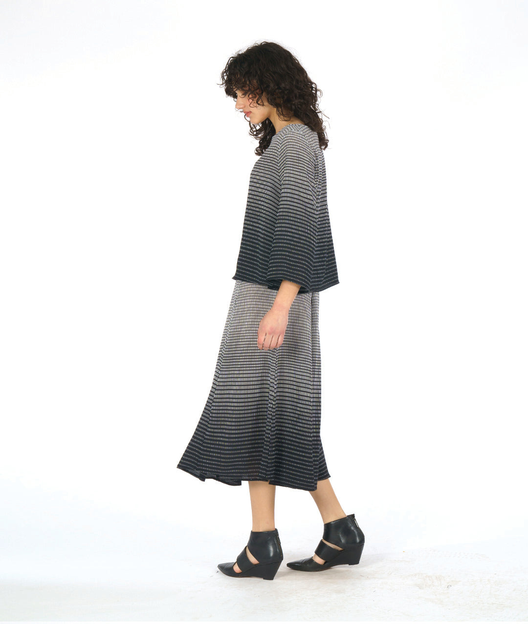 model in a black and white ombre grid print paneled skirt with a matching boxy top