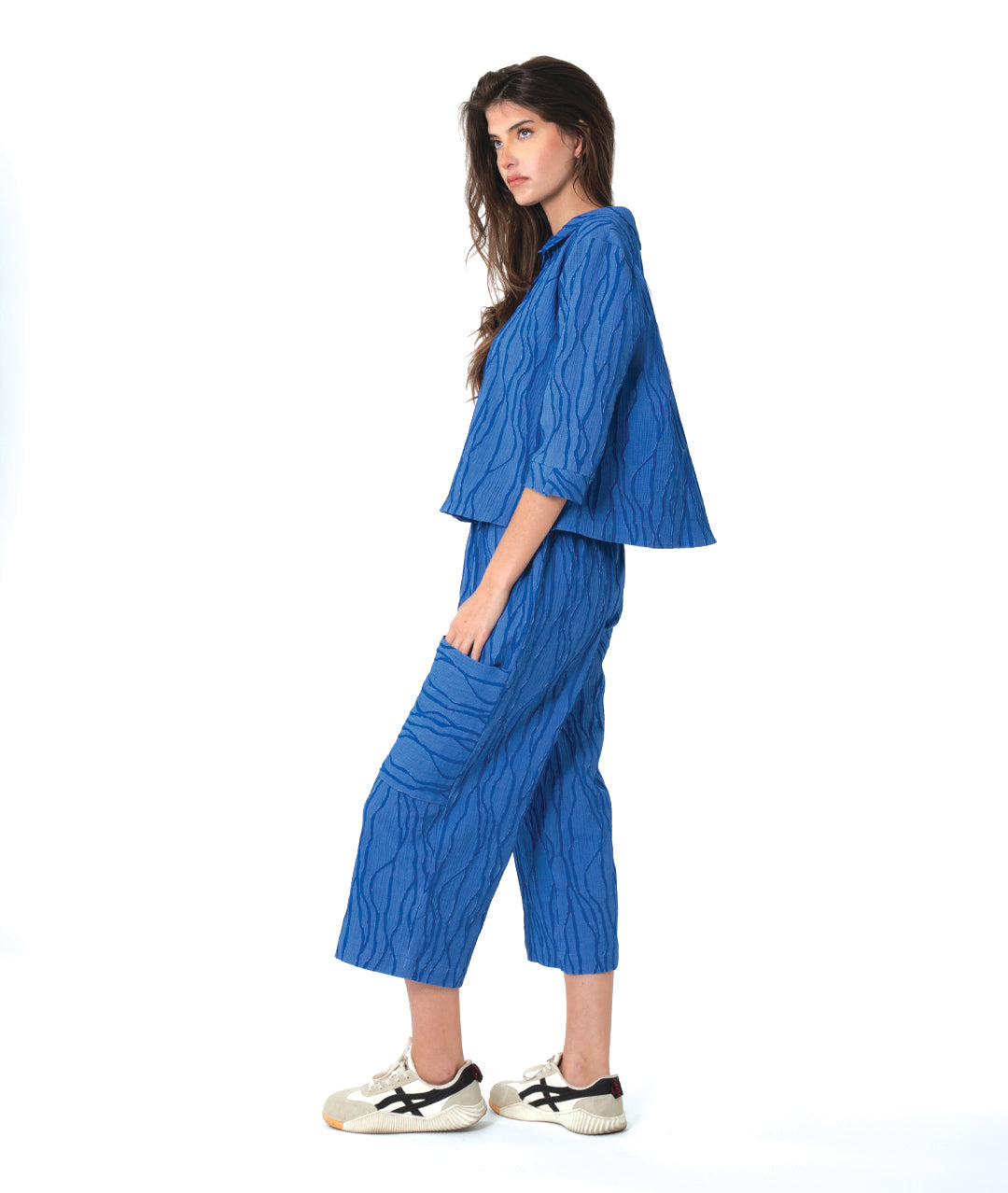 model in a boxy blue button down blouse with a matching straight leg cargo pant. 