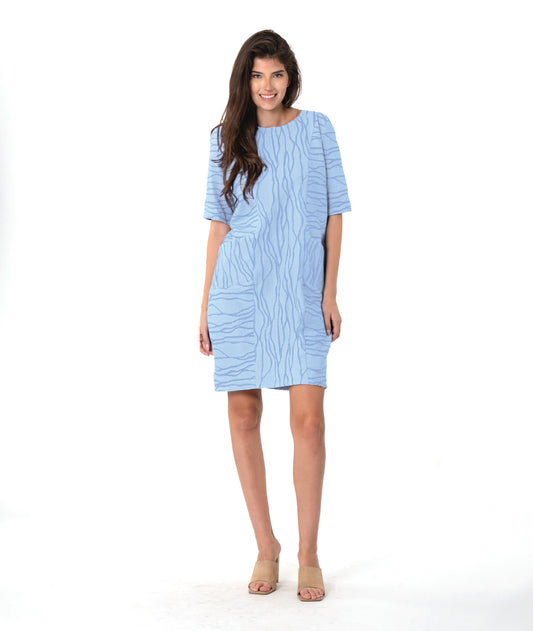 model in a light blue shift dress with princess seams and a wavy line texture