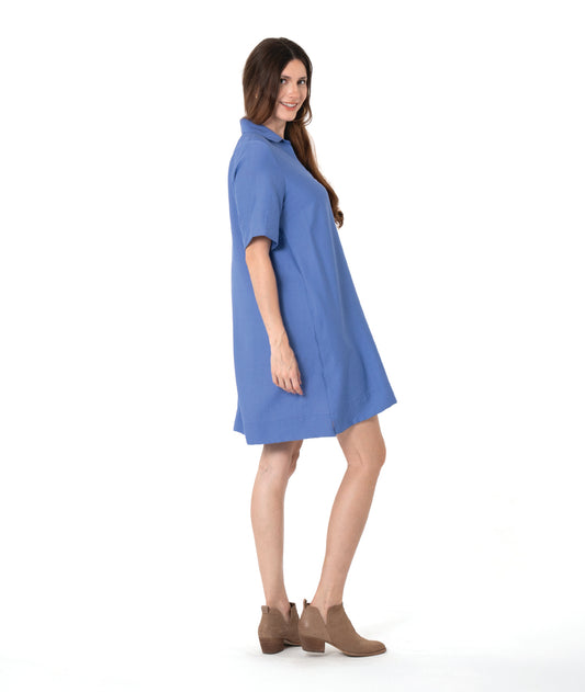 model in a periwinkle pullover knee length shirt dress with short sleeves and a collar
