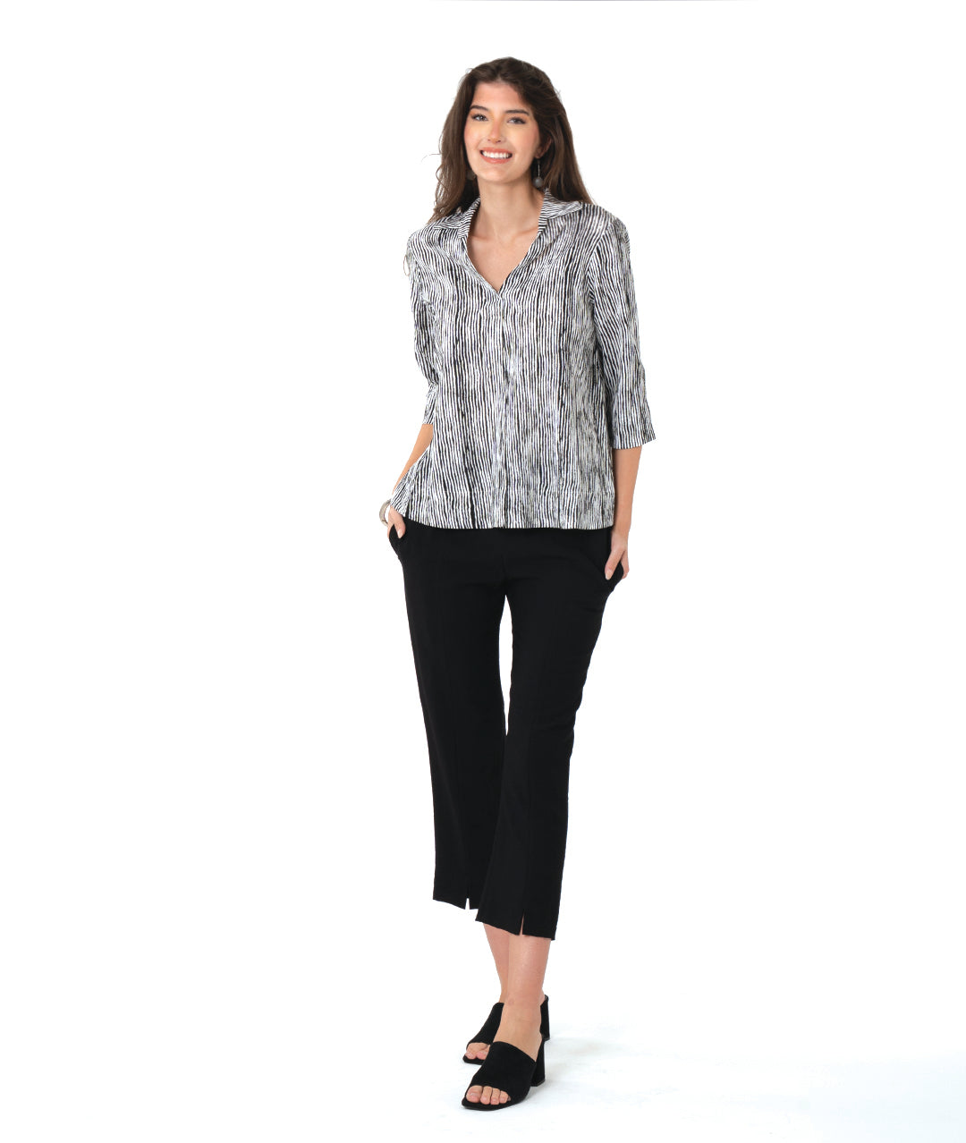 model in a slim black pant with a black and white striped 3/4 pullover 