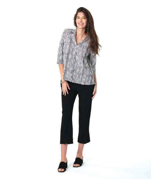 model in a slim black pant with a black and white striped 3/4 pullover 