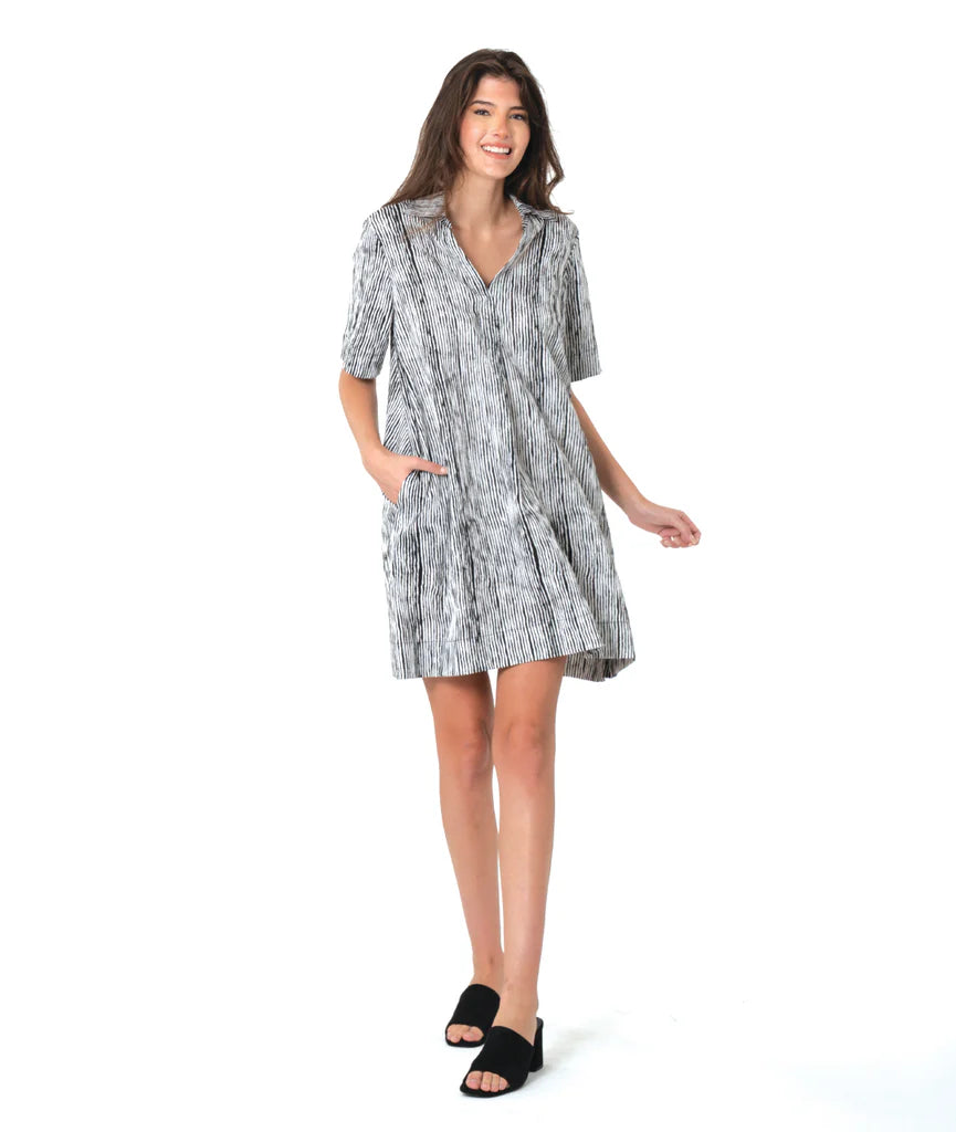 Woman wearing a striped black and white dress on a white background