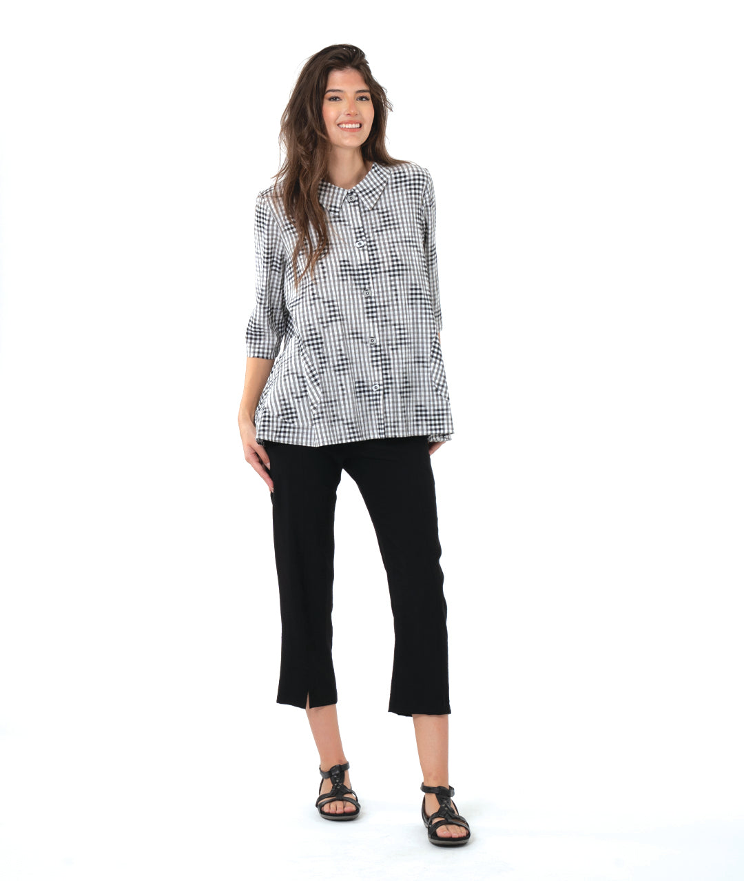 model in a slim black crop pant with a grey plaid blouse with 3/4 sleeves and a full body
