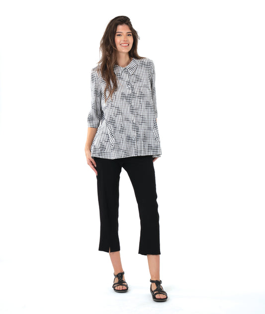 model in a slim black crop pant with a grey plaid blouse with 3/4 sleeves and a full body