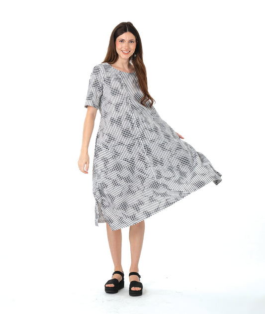 model in a grey plaid dress with asymmetrical tucks and panels