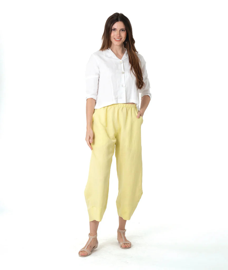 Woman wearing a white shirt and yellow pants on a white background