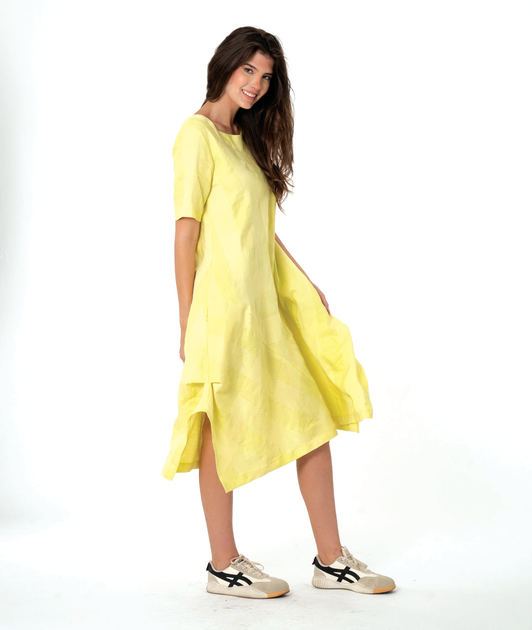 model in a large scale yellow check dress with contrasting angles and short sleeves