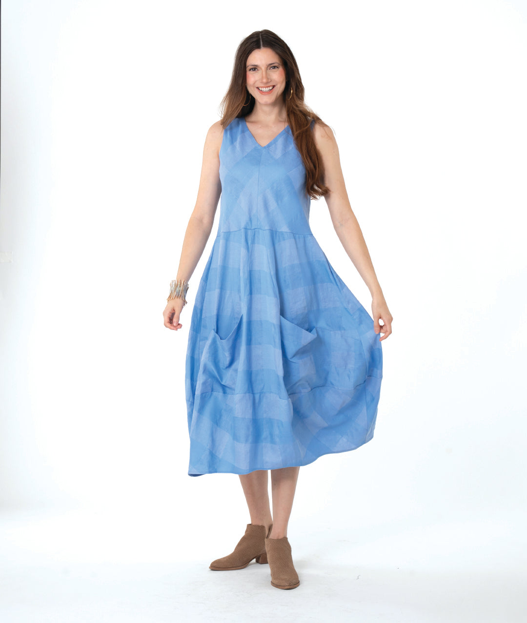 model in a blue checker sleeveless dress with a vneck and a tulip skirt shape