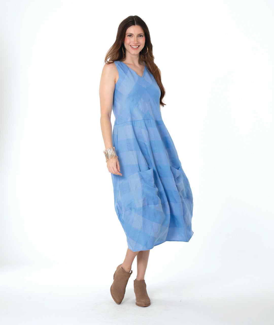 model in a blue checker sleeveless dress with a vneck and a tulip skirt shape