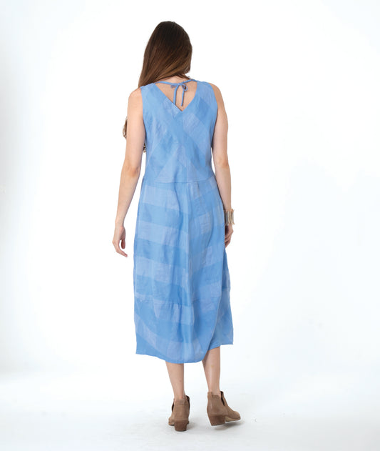 model in a blue checker sleeveless dress with a vneck and a tulip skirt shape