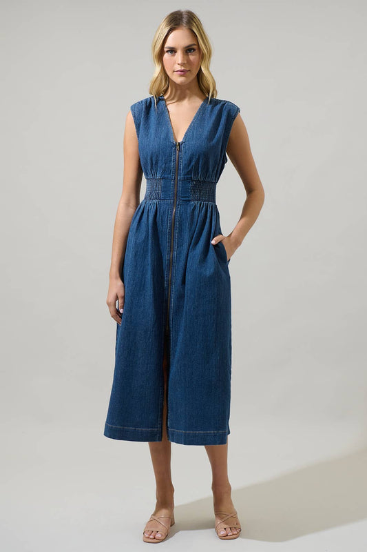model wearing a sleeveless midi denim dress with a v-neck, smocked waist and front zipper on a white background