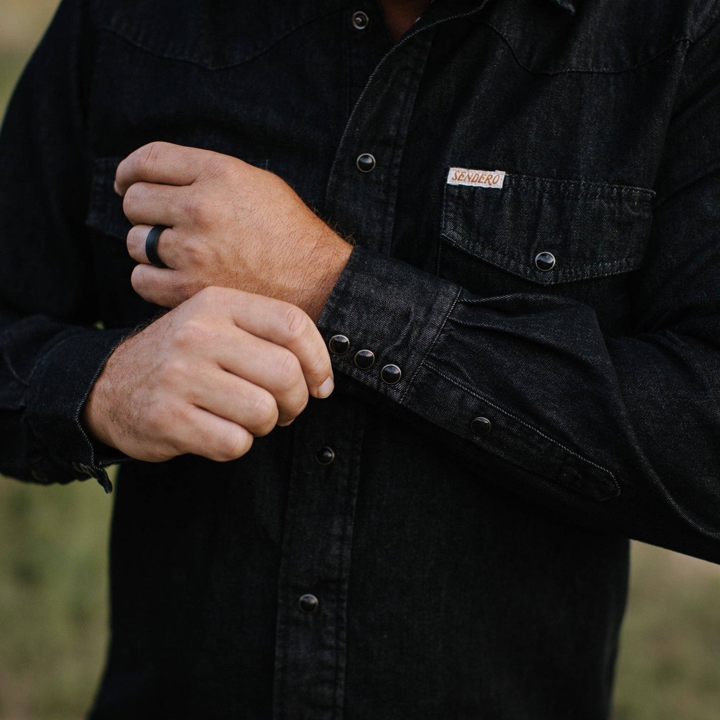 close up of black denim long sleeve shirt