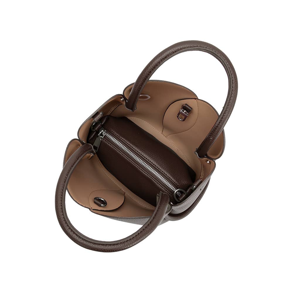 Two-toned handbag with a maroon interior and beige exterior on a white background