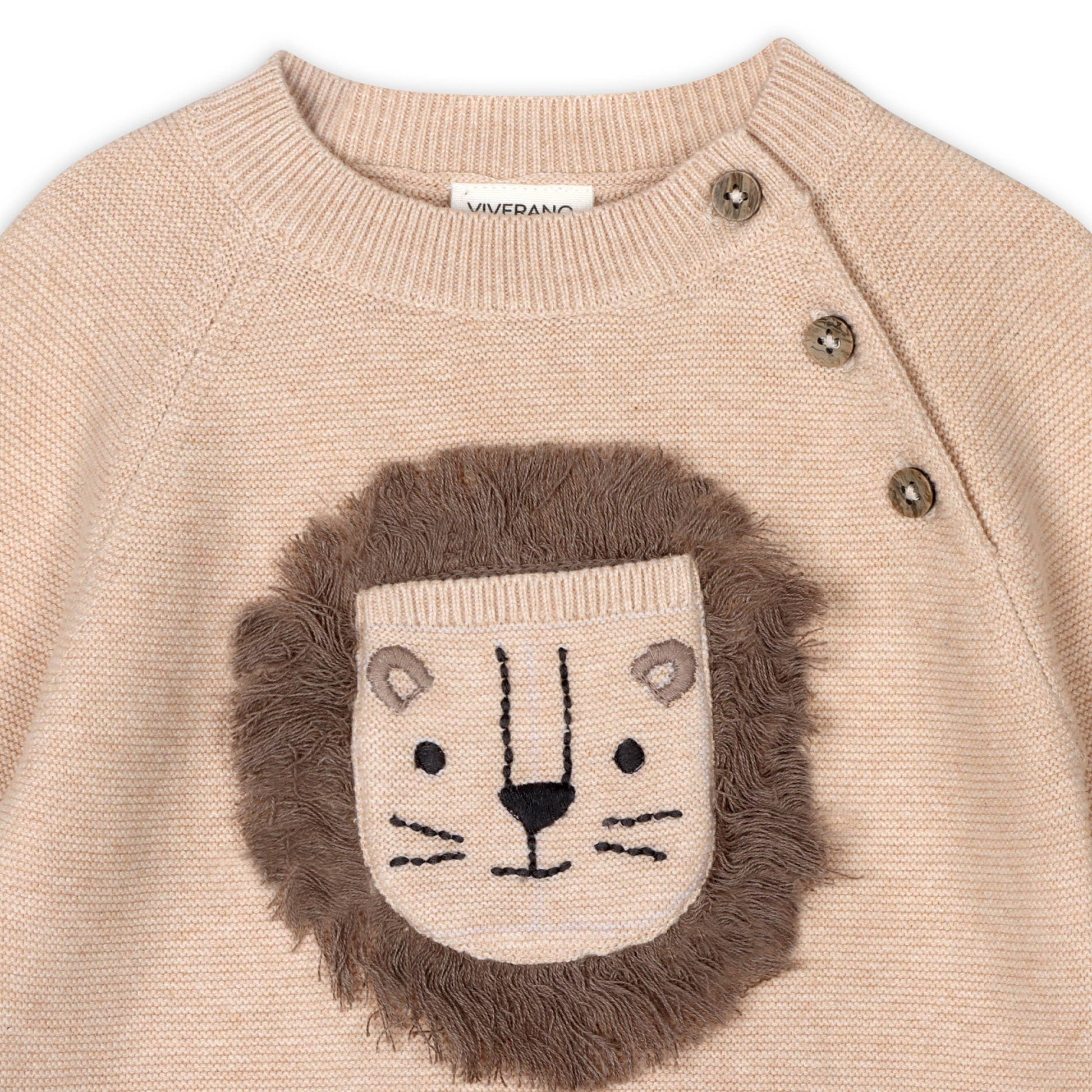 Beige sweater with lion face design on a white background