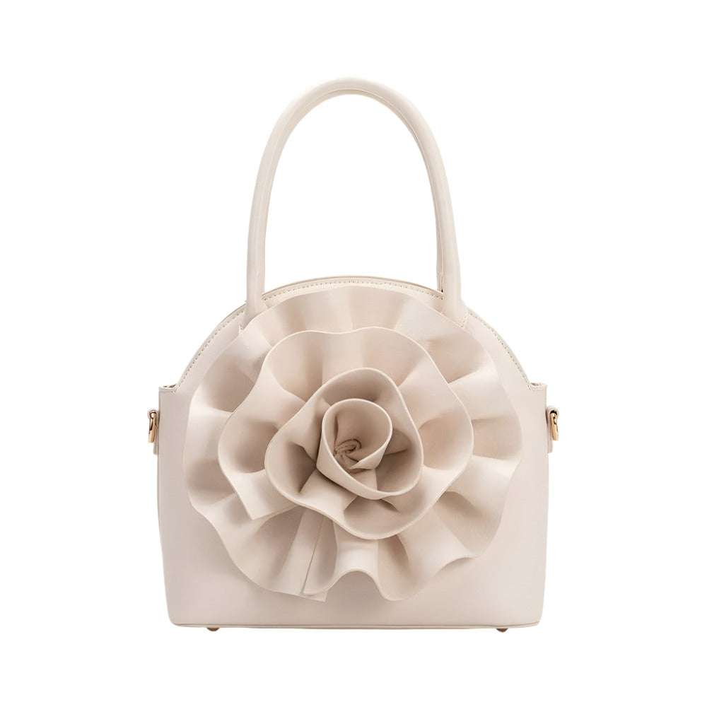 ivory handbag with large flower detailing on white background