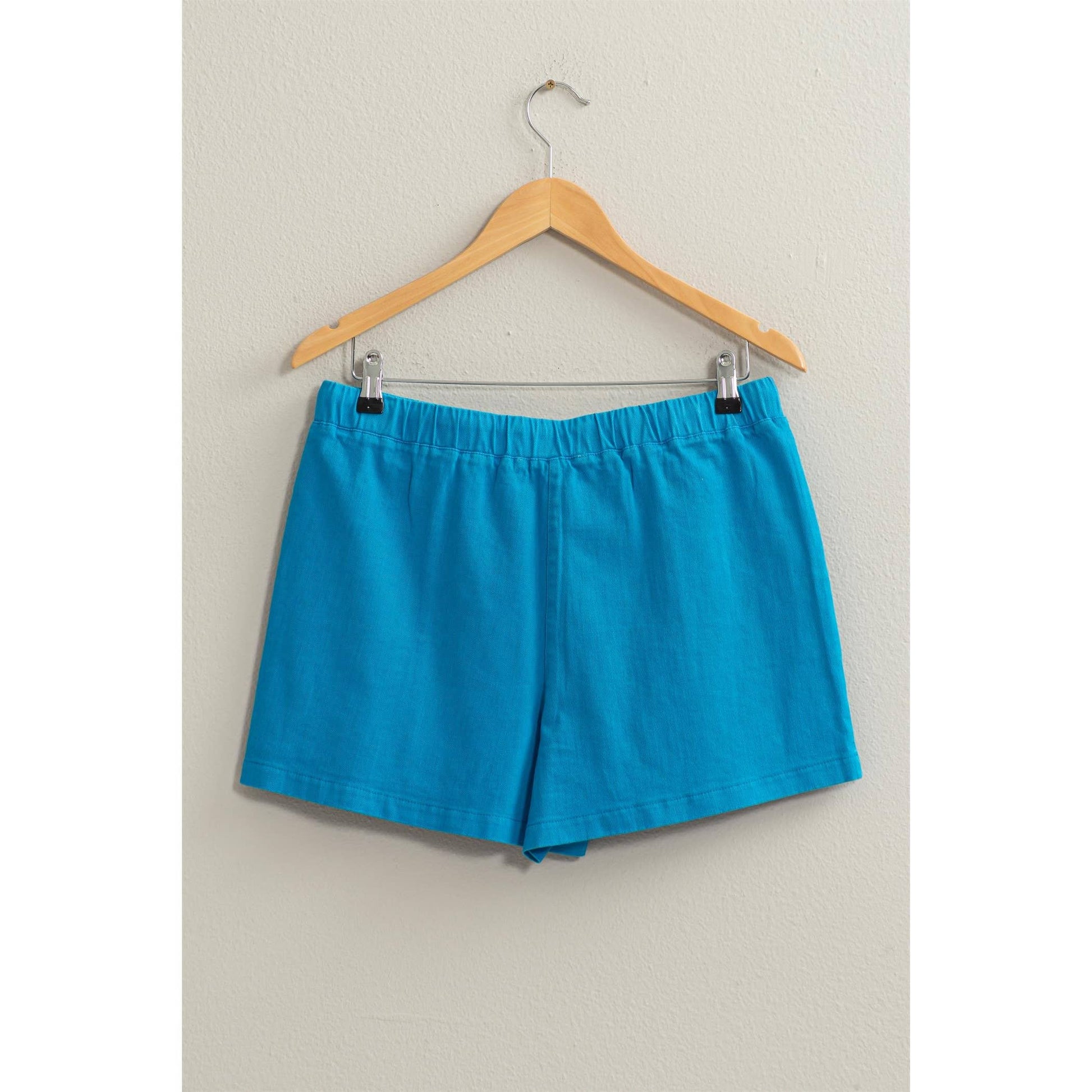 showing back of blue drawstring shorts on hanger