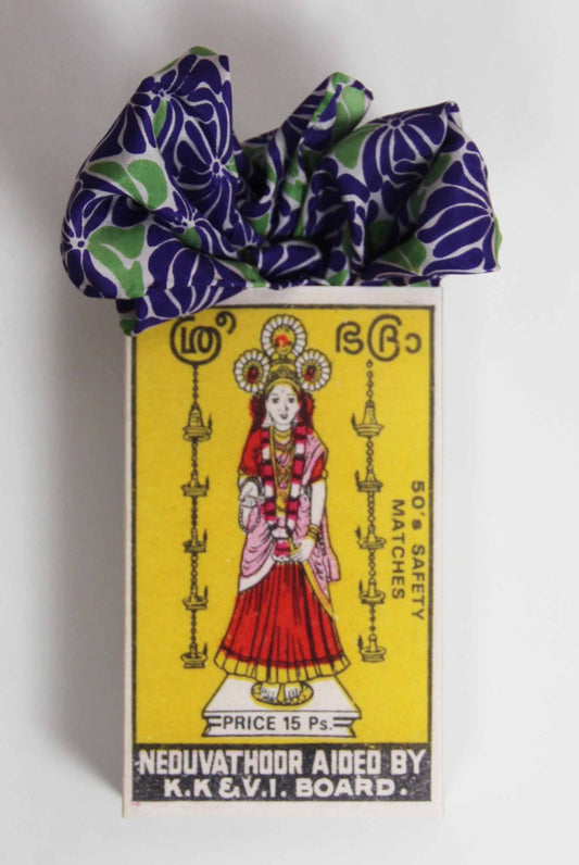 Matchbox with a colorful design and text on a white background