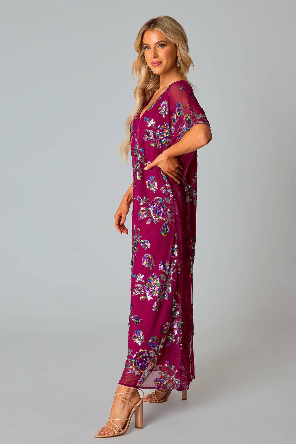 model wearing red sangria colored short sleeve v-neck maxi dress with colorful sequin pattern