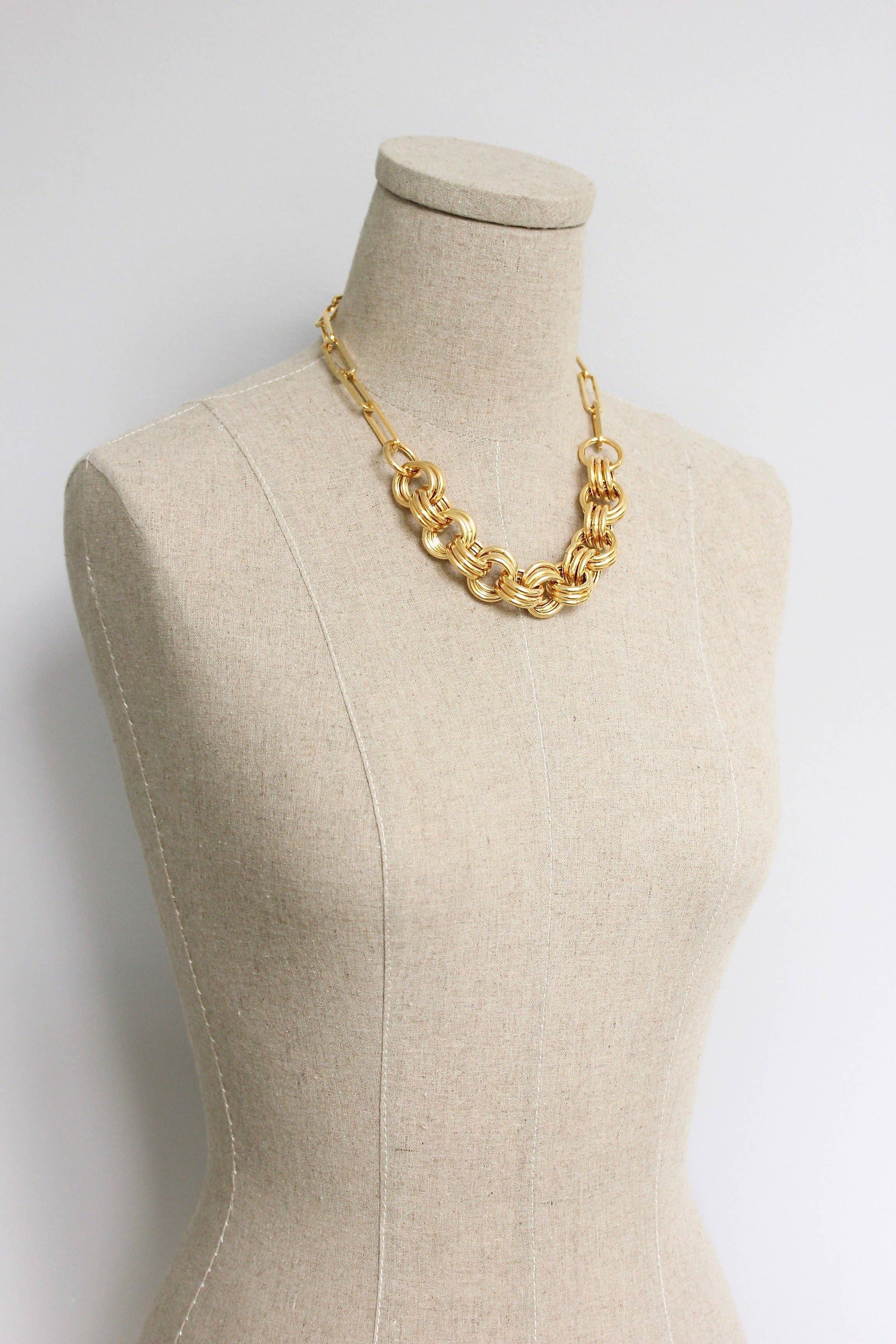 18” 18k gold plated brass chain necklace with 3 inch extender on a neck stand