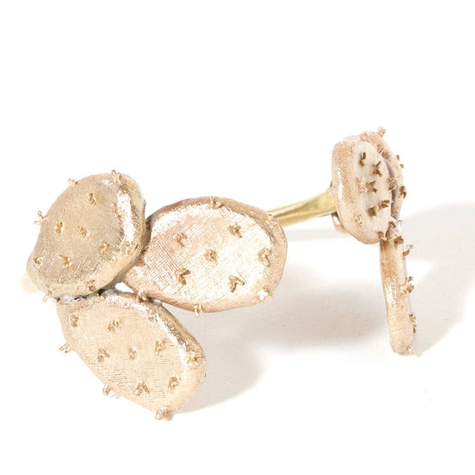 A gold-toned ring featuring three textured, cactus-like oval pads with small raised studs, shown on a white background.