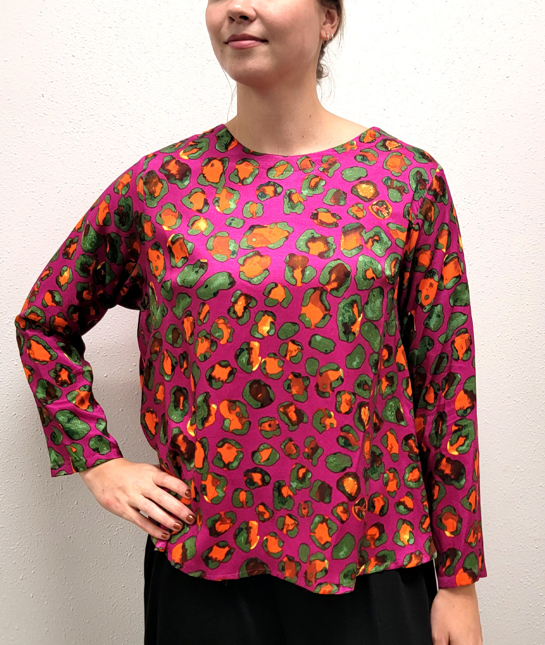 model is wearing brightly colored animal print shirt