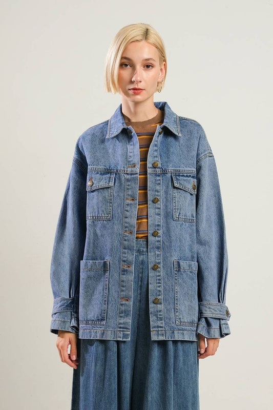 model wearing jean jacket with jeans and striped brown shirt