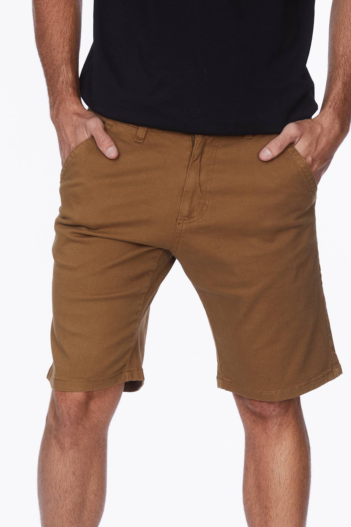 Male model wearing tobacco colored shorts with a black tee.