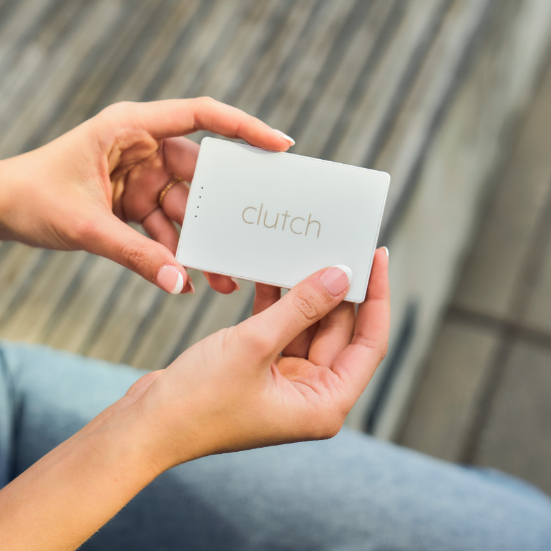 hands holding a white portable charger