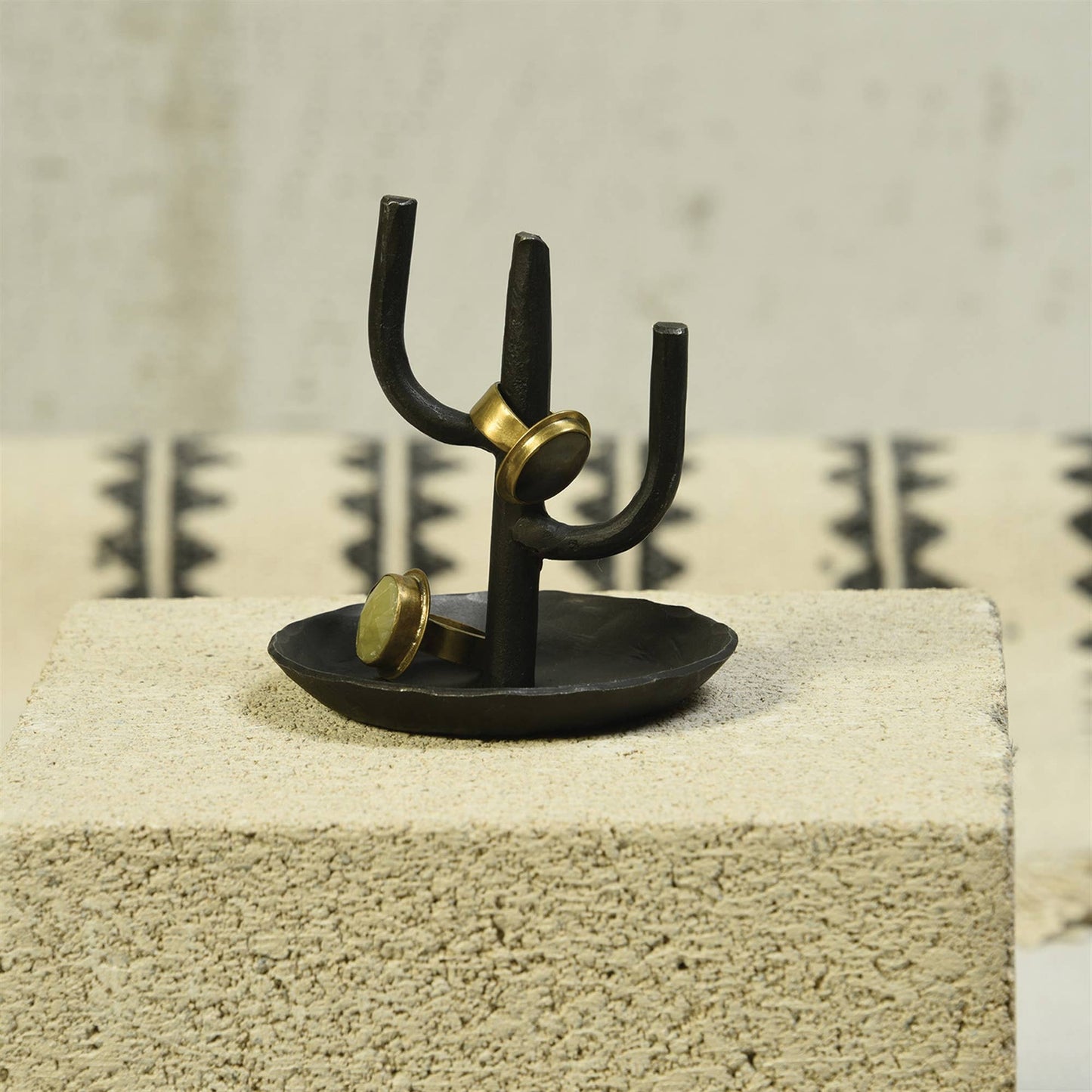 black iron cactus ring holder holding two rings