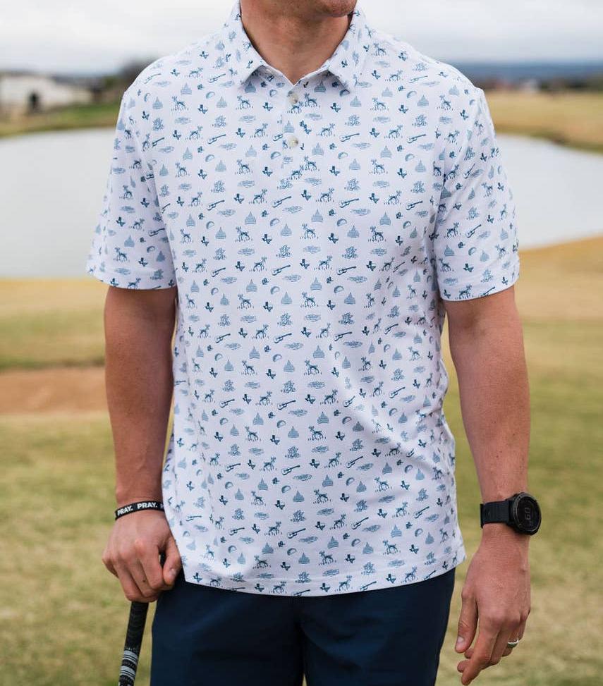 male model wearing white polo with blue print, outdoors