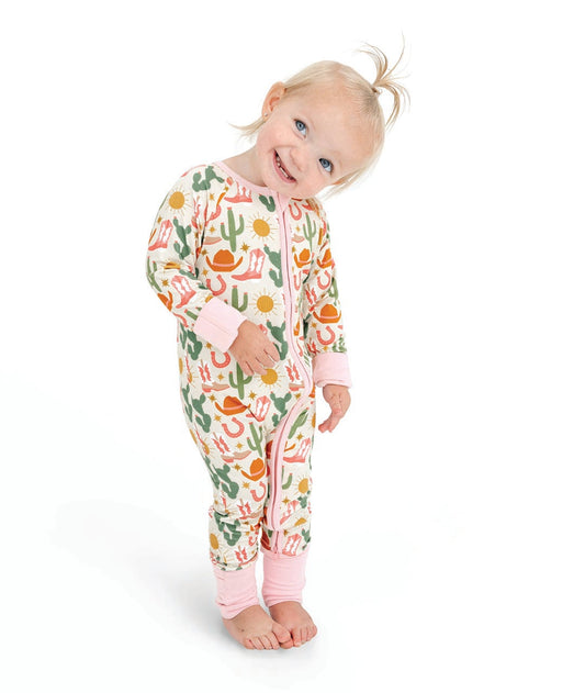 Baby wearing a colorful onesie with a white background