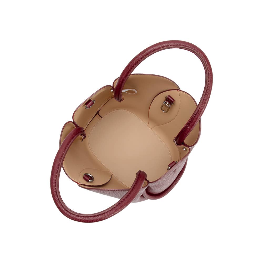 Small handbag with red handles on a white background