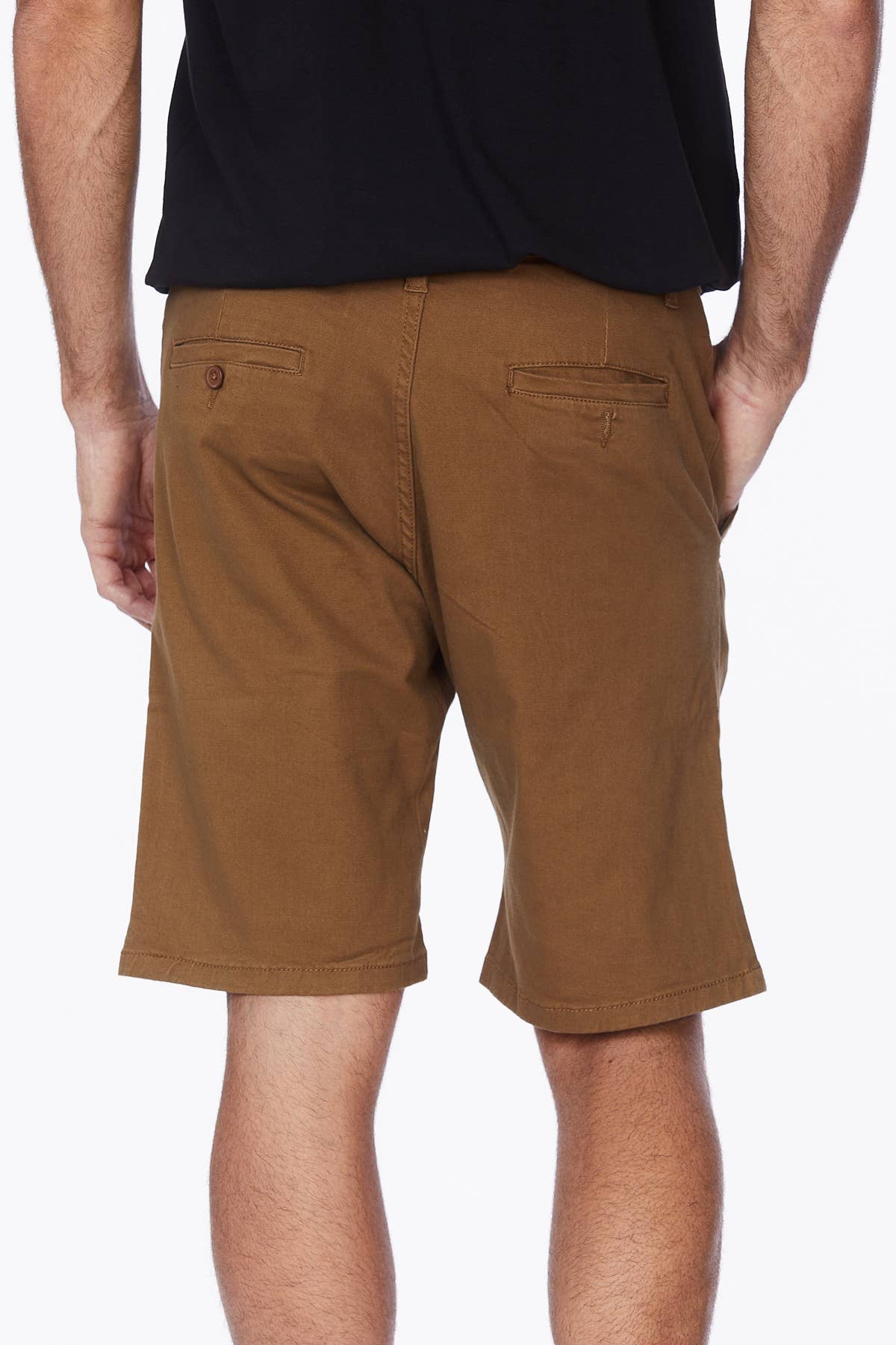 Male model wearing tobacco colored shorts with a black tee.