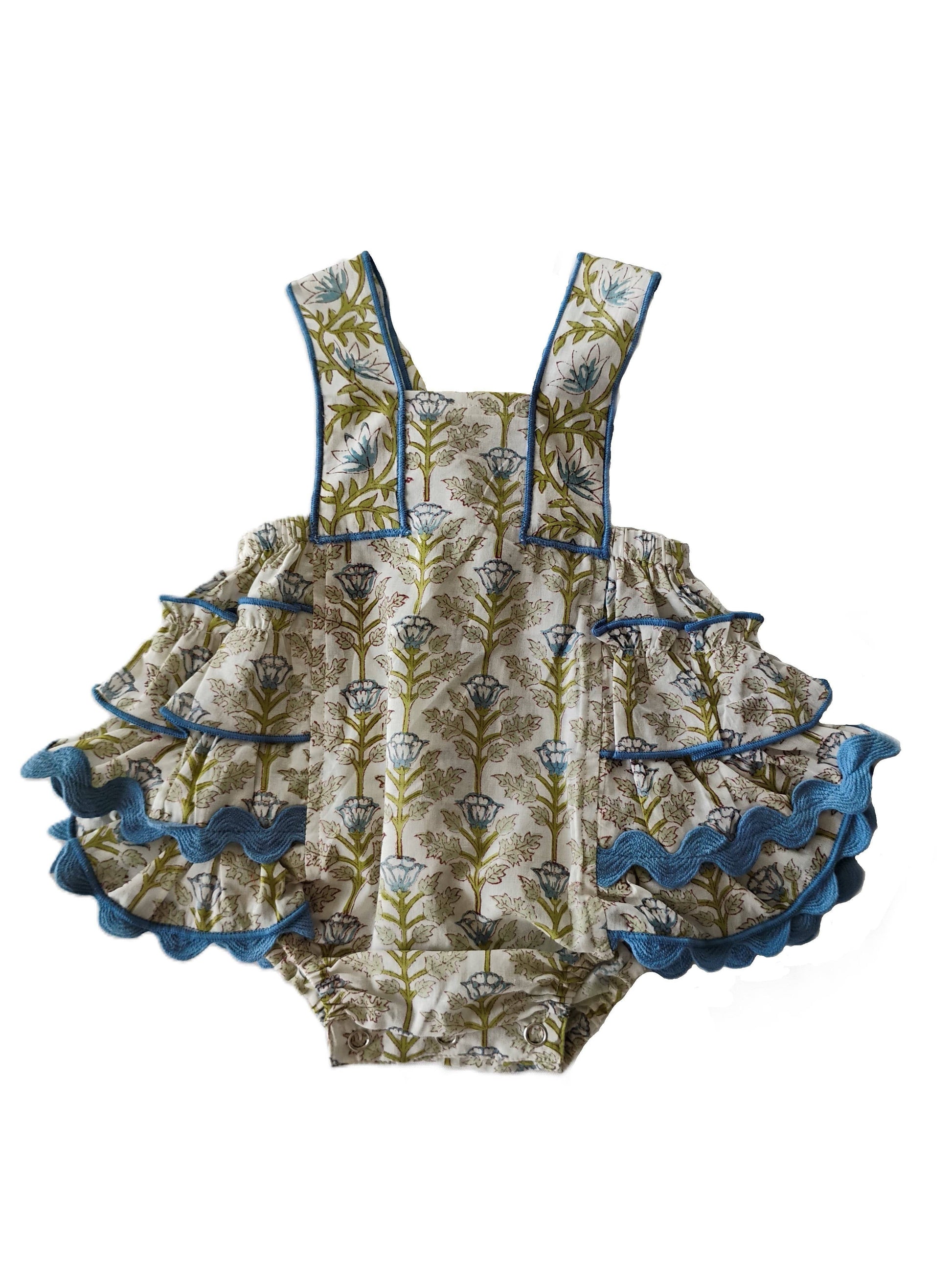 Children's romper with floral pattern and ruffled details on a white background