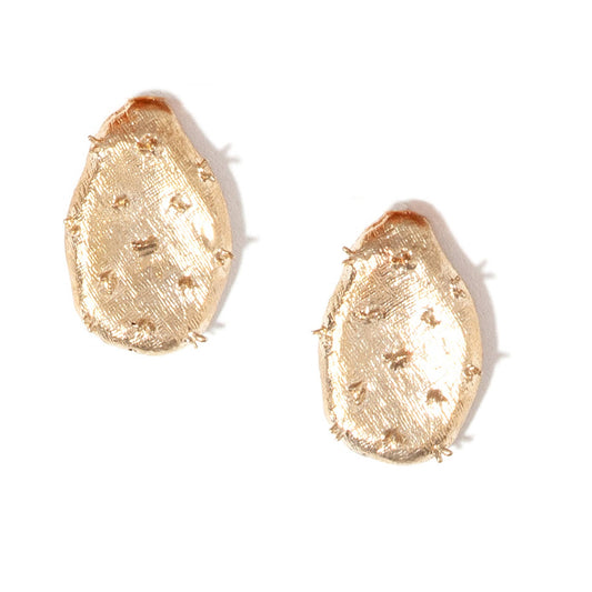 A pair of textured, organic-shaped gold earrings with a hammered finish and small raised details, shown on a plain white background.