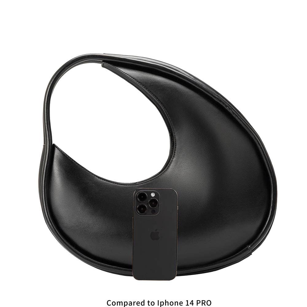 black circular asymmetrical shoulder bag with double piping structured handles compared to iPhone 14 pro