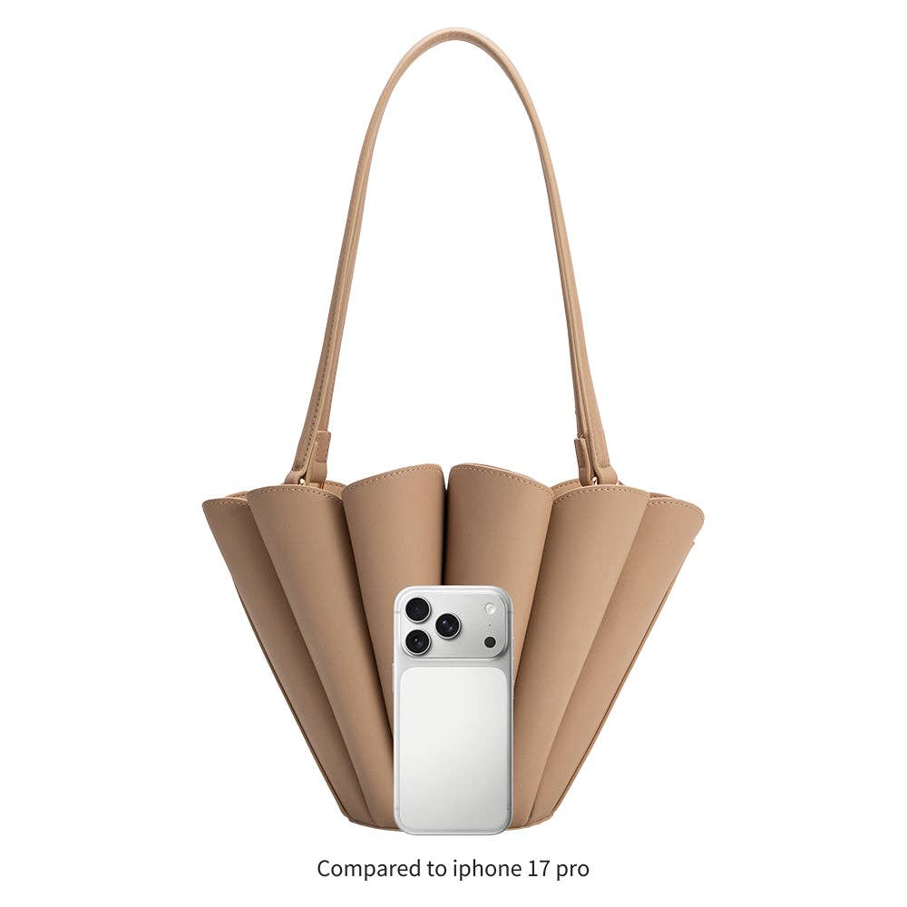 Beige handbag with a phone inside, compared to an iPhone 17 Pro on a white background