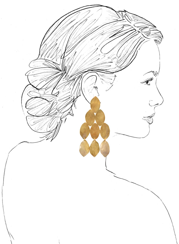 Tiered oval hammered brass dangle earrings set against a white background with sketch of a women to scale